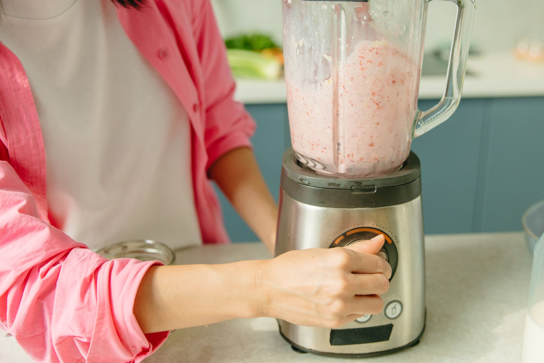 Person operating blender for food preparation