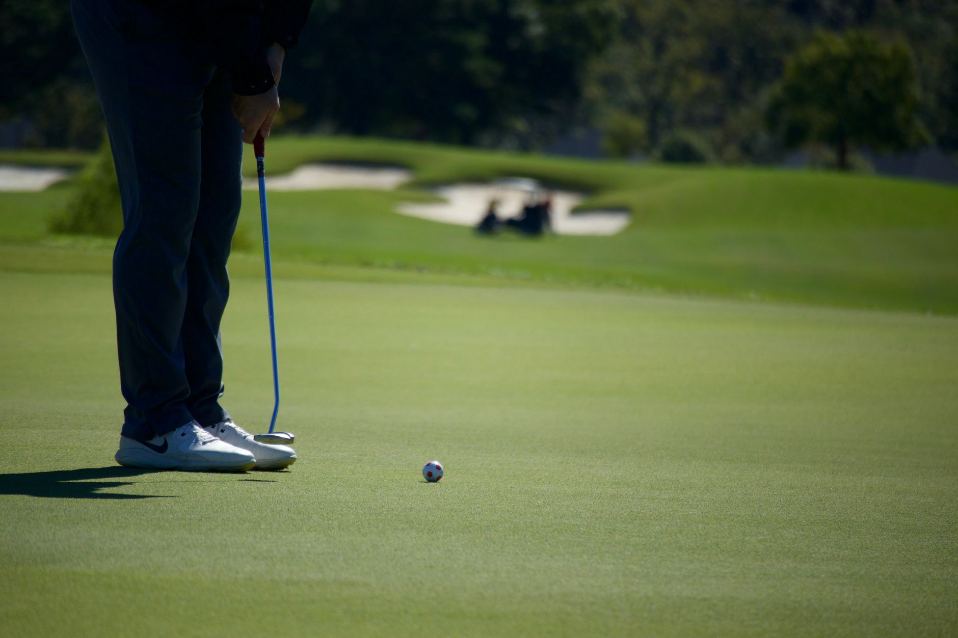 Golfer putting on green